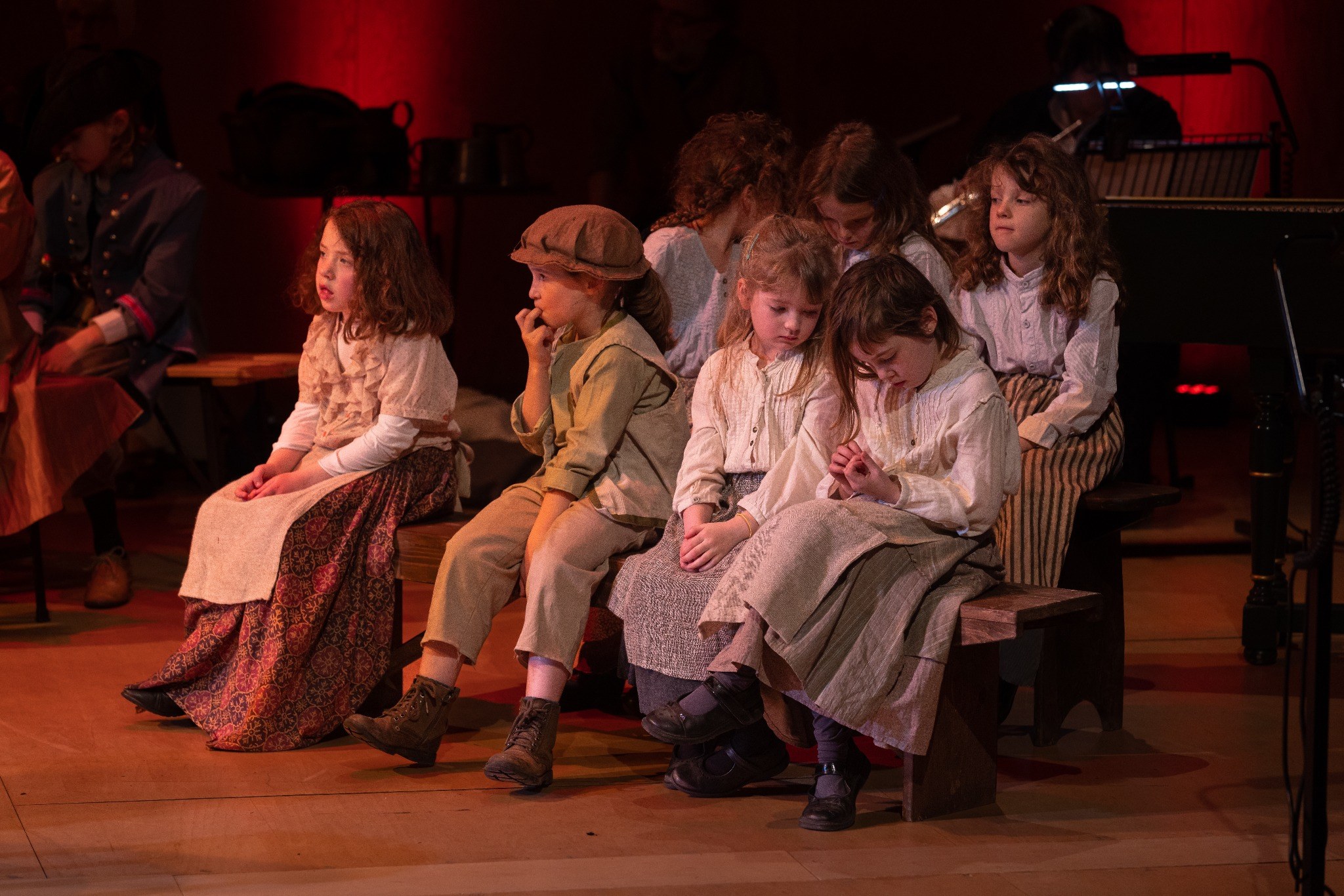 Young performers seated during a Jubilee Opera production